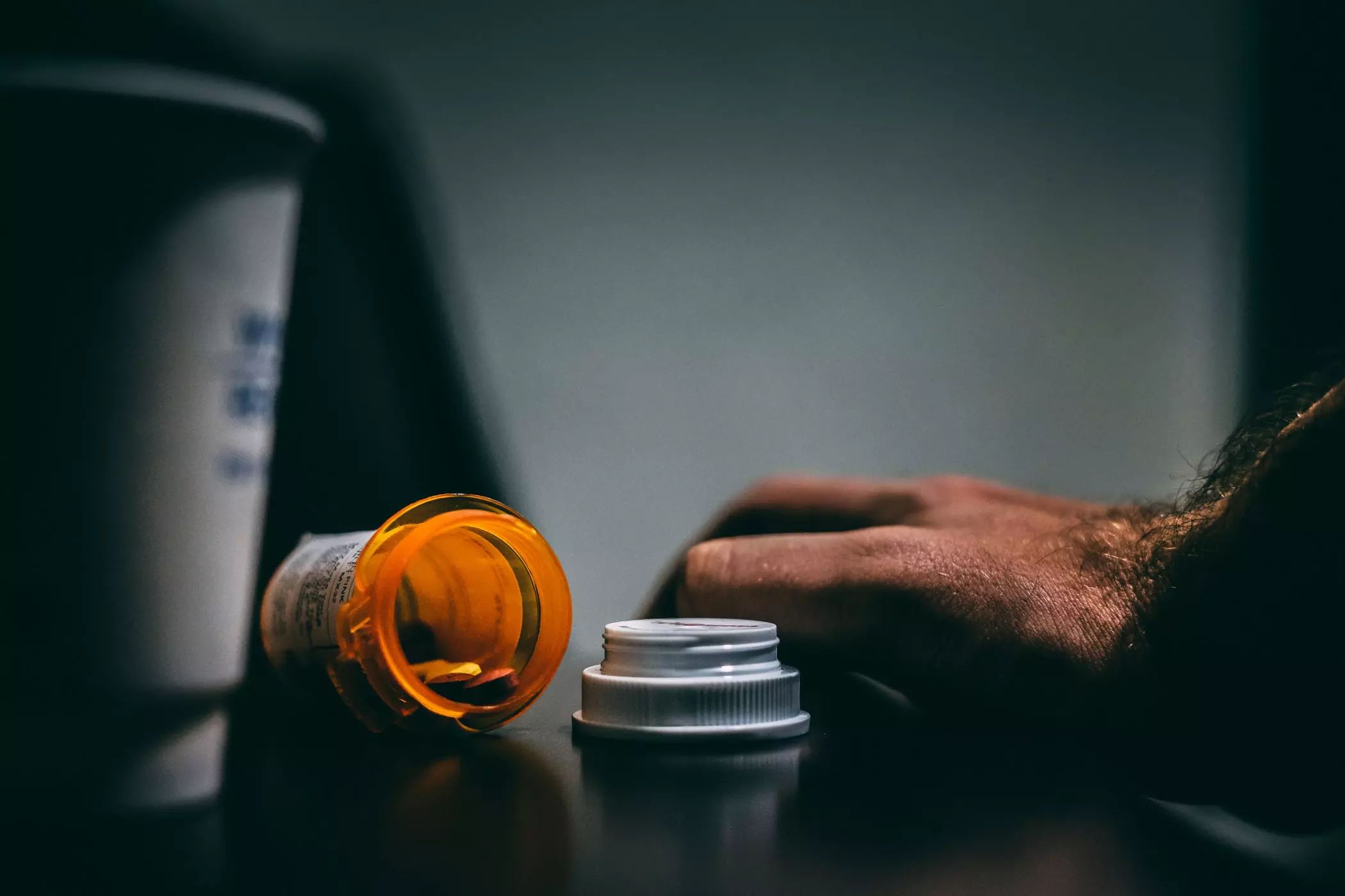 An open pill bottle on the counter.