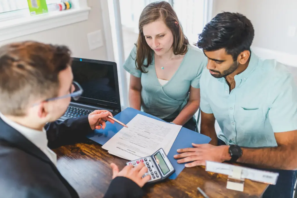 A couple working with an attorney.on paperworkl