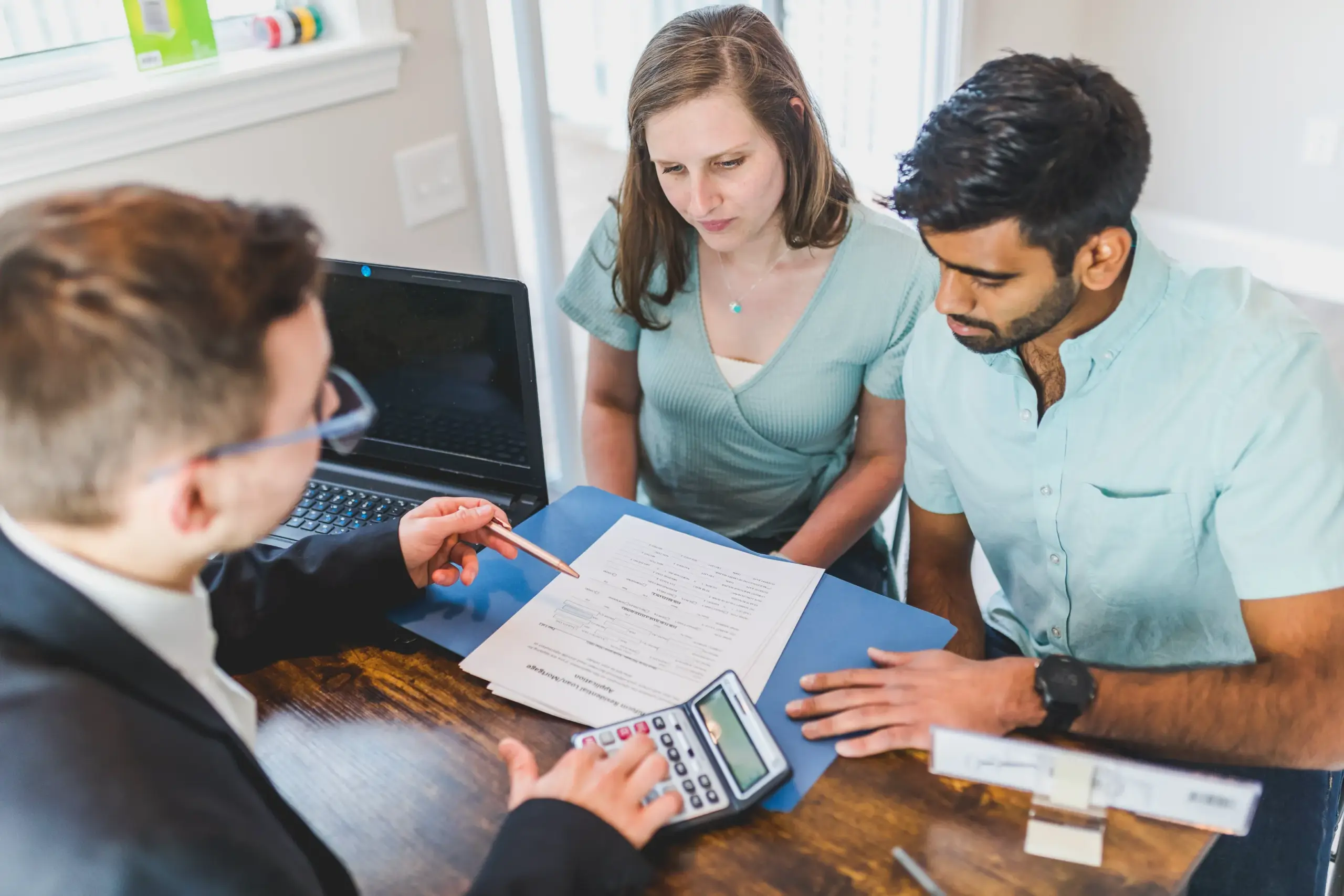 A couple working with an attorney.on paperworkl