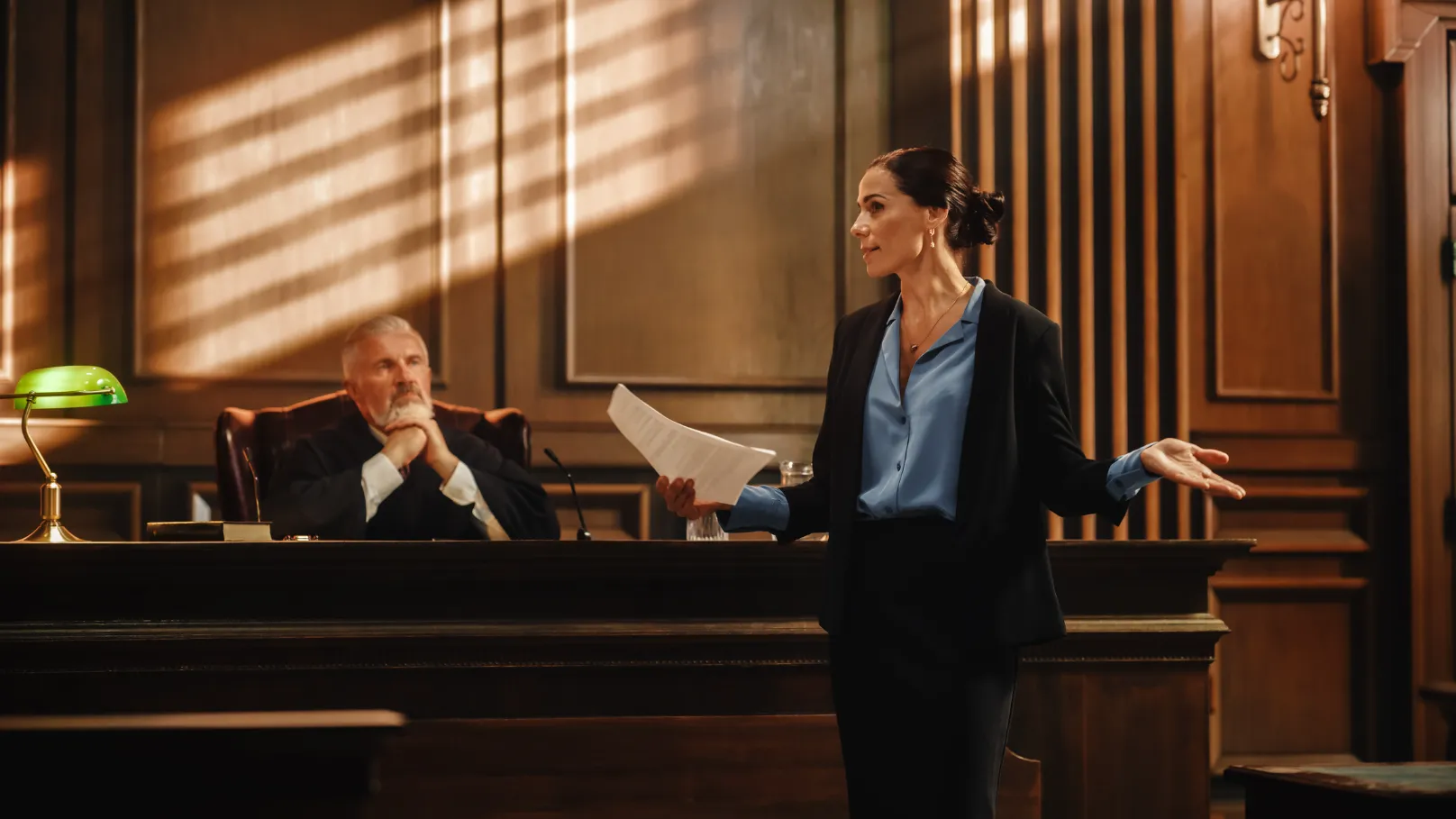 Woman attorney in front of a judge in a courtroom.