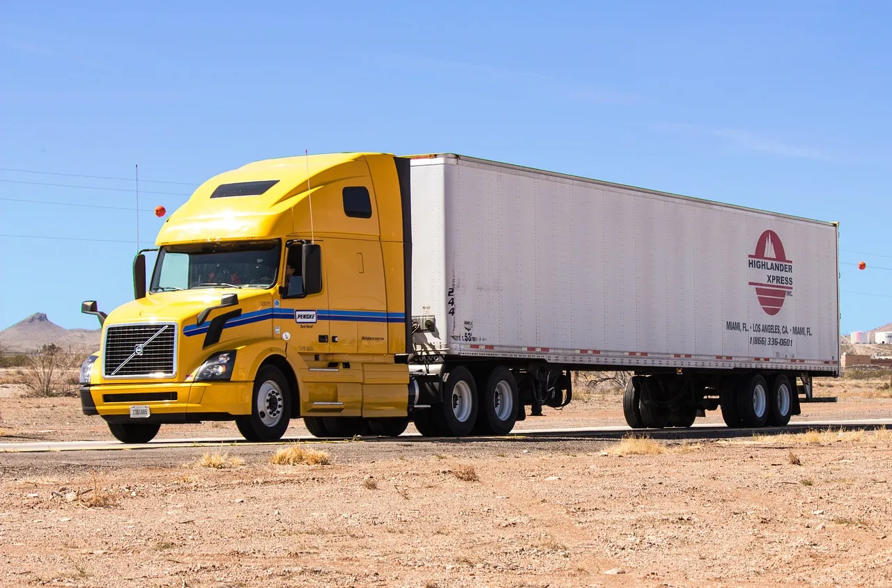 large 18 wheeler with a yellow cab. 