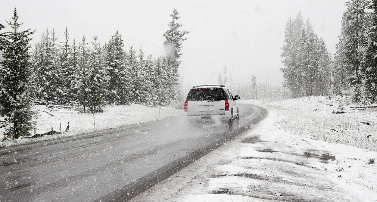 An SUV driving in snow.