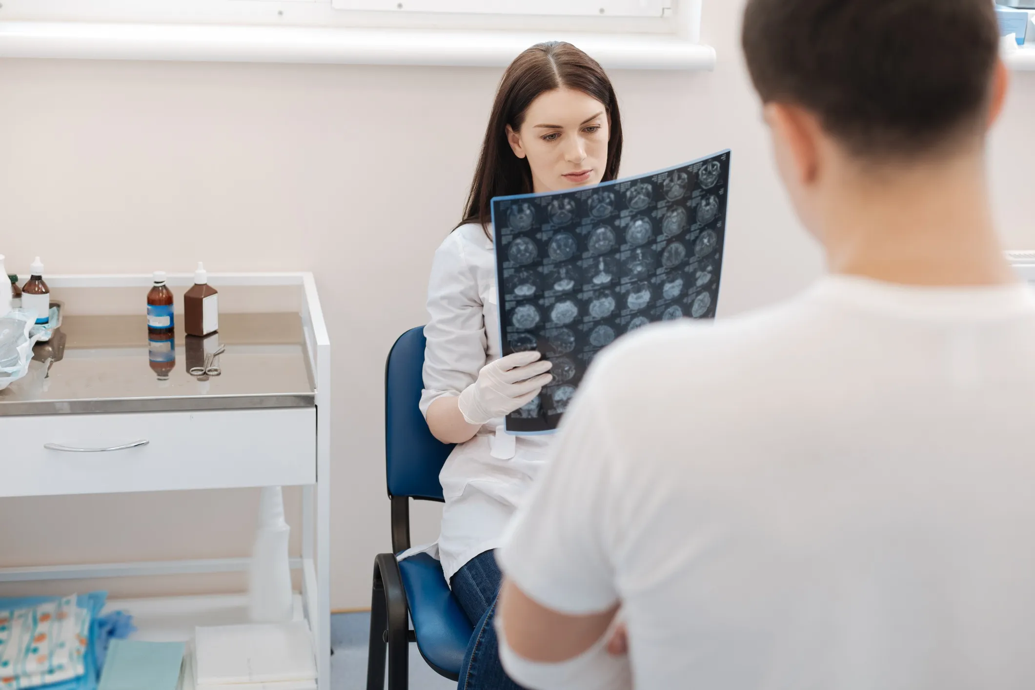 A female doctor reviewing MRIs.