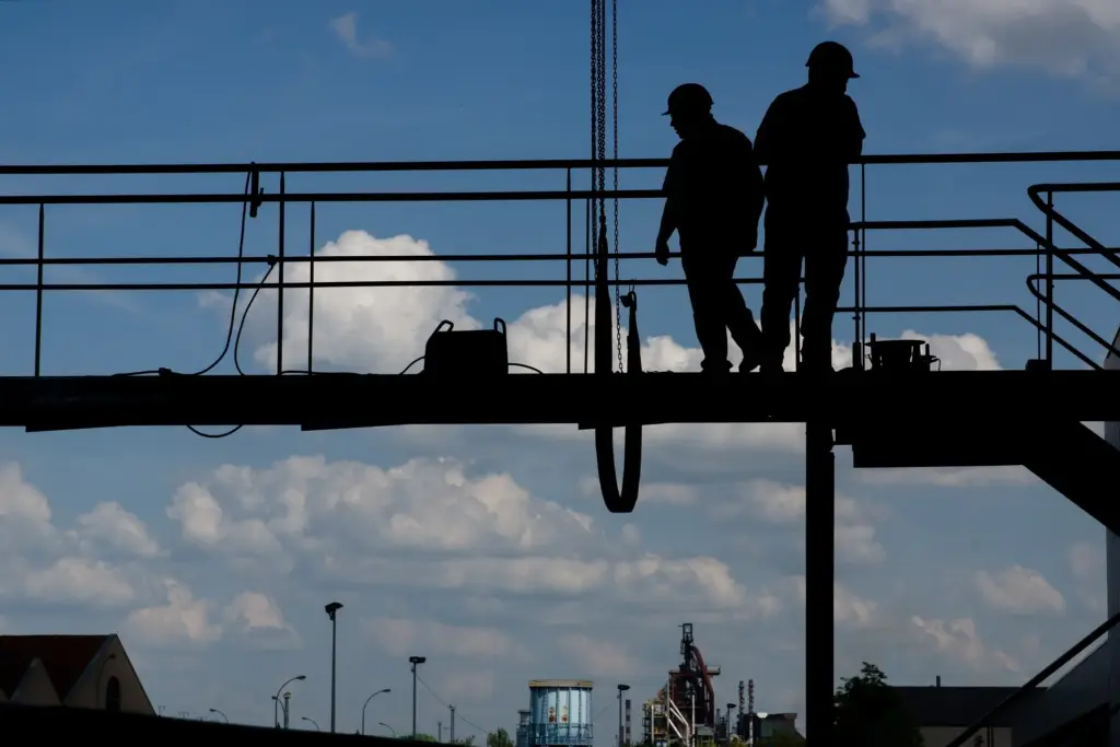 Construction workers on a walkway.
