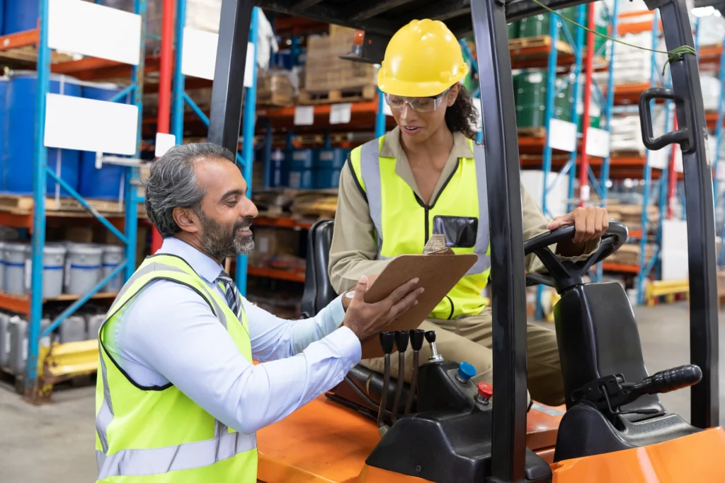 Worker being trained to operate forklift.
