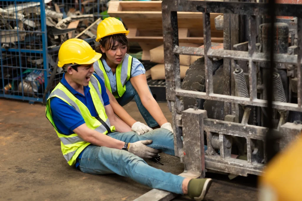 A man trapped under a forklift.
