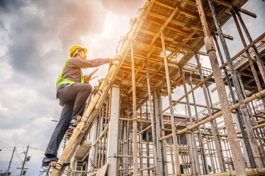 A construction worker climbing a ladder on a construction site.