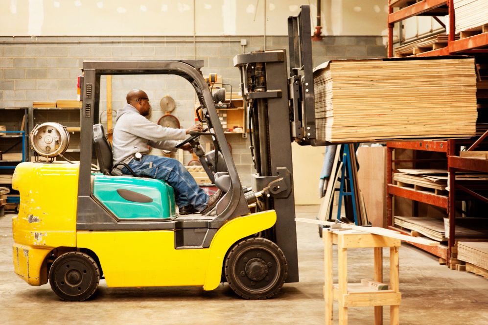 A worker operating a forklift.