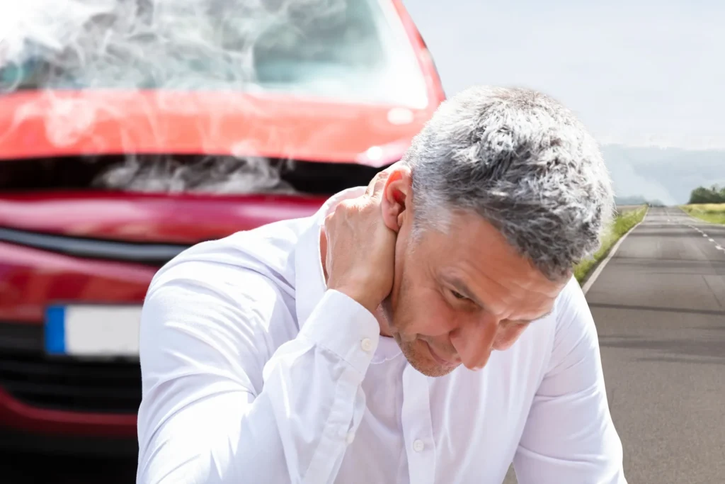 A man holding his neck after a car accident.
