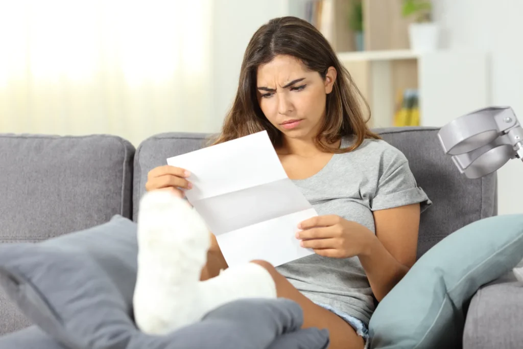 An injured person reviewing their medical bills.