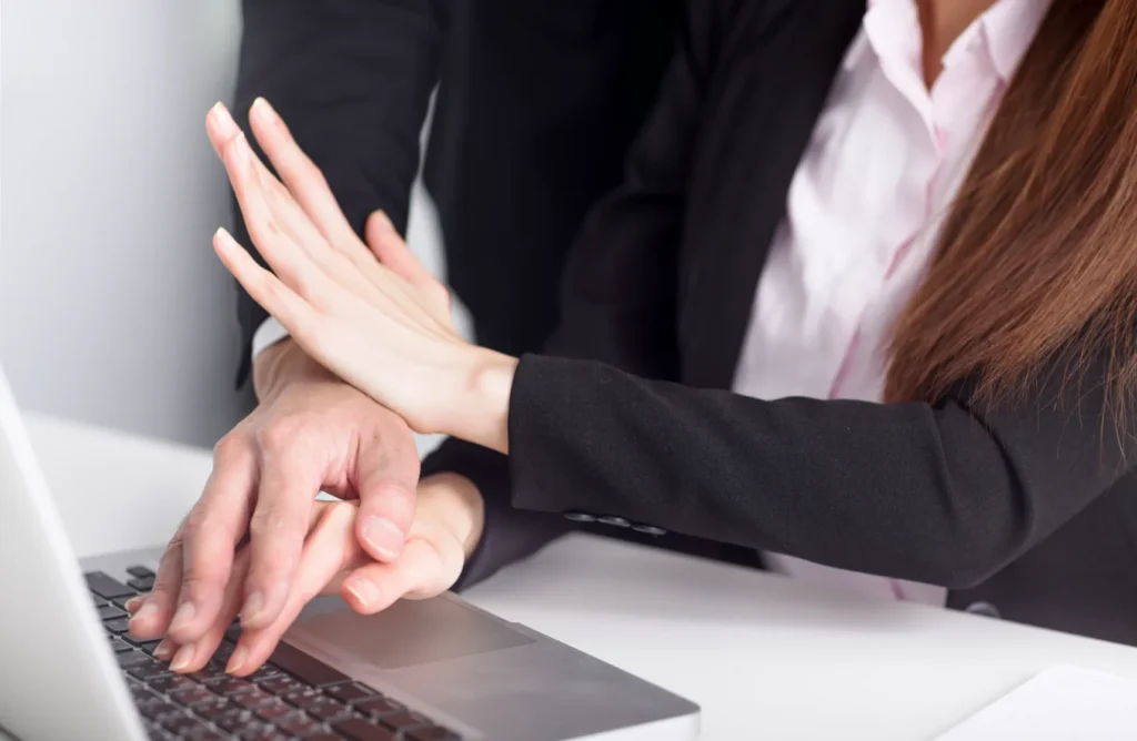 A woman pushing a mans hand away from her.