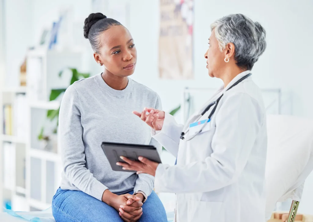 A sexually assaulted woman speaking with a doctor.