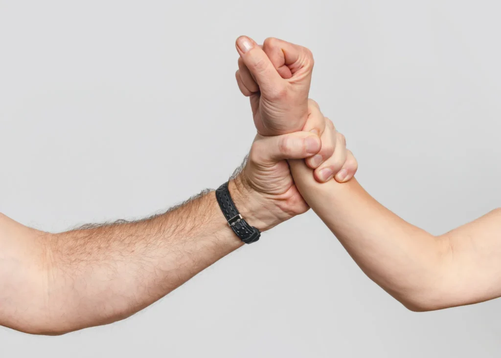 A man grabbing a woman forcefully by the wrist.
