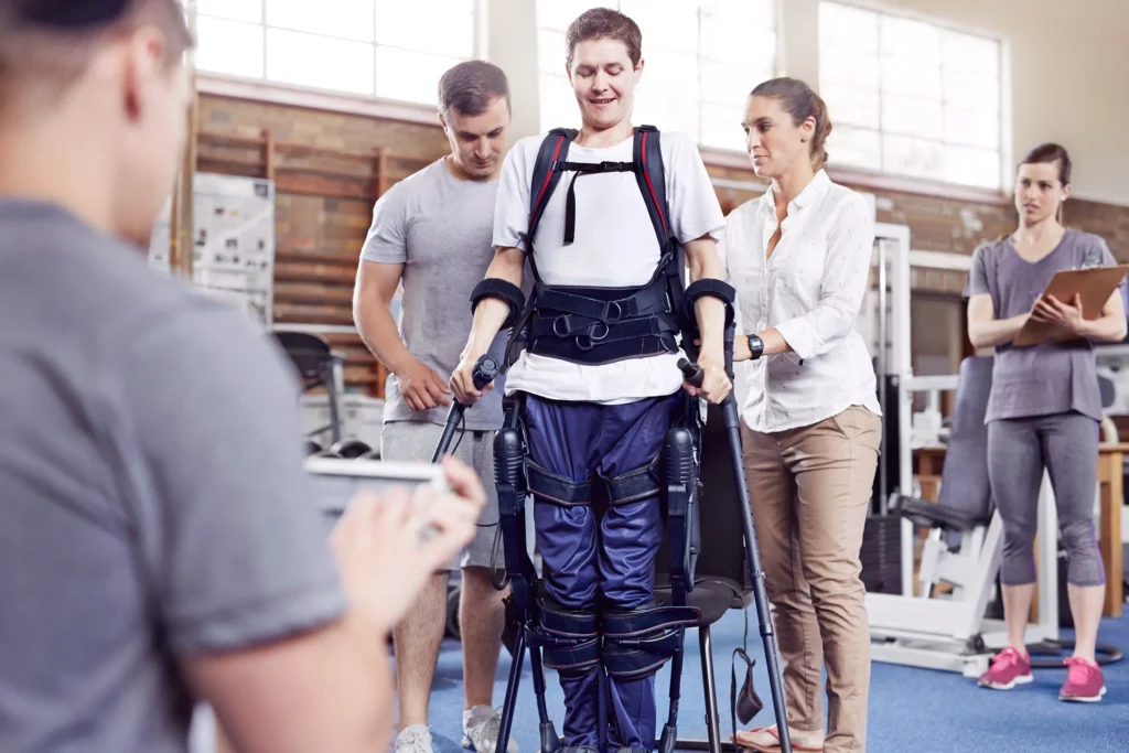 A patient in physical therapy trying to walk.